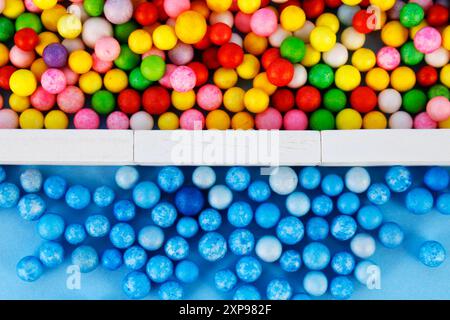 Blue spheres separated from other spheres of different colors by a wall made of rectangular wooden figures - horizontal format Stock Photo