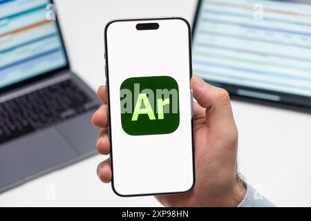 PRAGUE, CZECH REPUBLIC - JANUARY 21 2024: Adobe Aero logo on the screen of smartphone in mans hand on the workplace background.  Stock Photo