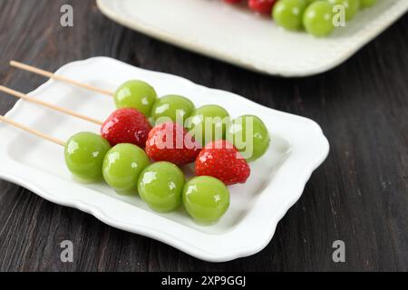 Tanghulu, Chinese Candied Fruit Skewers. SUgar Coated Shine Muscat and Strawberry, Street Food Stock Photo