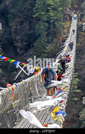 Trekkers crossing the Larche Dovan bridge below Namche Bazaar on the Everest Base Camp trek Stock Photo