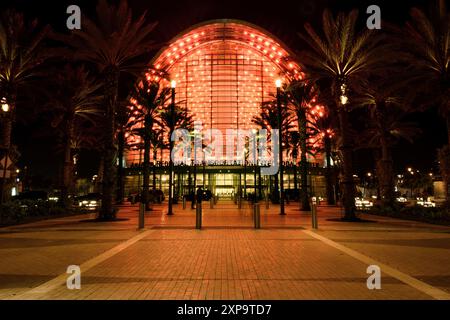 Anaheim Regional Transportation Intermodal Center ARTIC a local transportation hub providing rail, bus and taxi services illuminated in red at night. Stock Photo