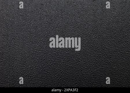 Orange peel texture on black motorbike seat leather. Black rough surface background Stock Photo