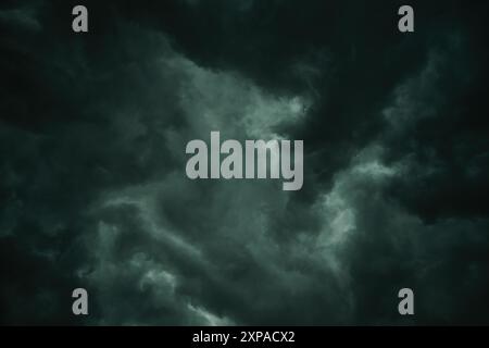 Stormy sky with heavy dark clouds in summer, low angle view Stock Photo