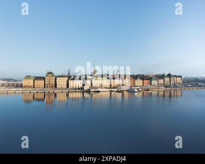 Stockholm old town - Gamla Stan - in early summer morning with medieval houses reflected in calm water with clear blue sky Stock Photo