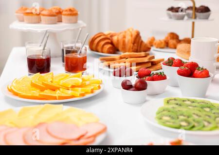 Different meals served on white table indoors, selective focus. Buffet menu Stock Photo