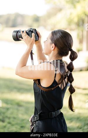 Professional female photographer with dslr camera photographing
