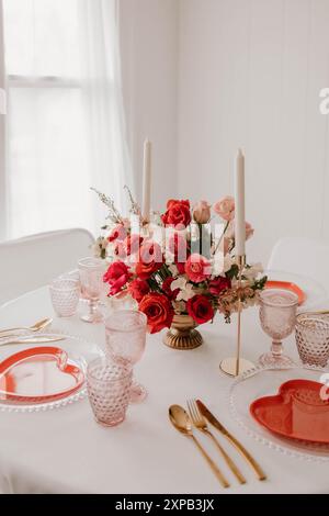 Romantic table setting with red roses and candles Stock Photo
