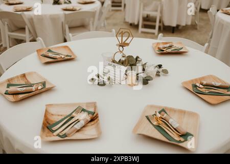 Wedding reception table with wooden plates Stock Photo