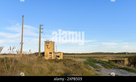 Arles, France - March 23, 2023: Old transformer station at canal near Arles on a sunny evening in winter, blue sky Stock Photo