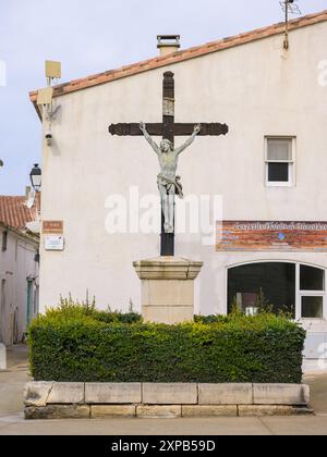 Saintes Maries de la Mer, France - March 9, 2023: Crucifix near the church of Saintes Maries de la Mer on a cloudy day in springtime Stock Photo