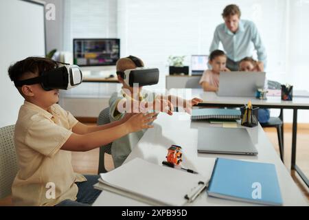 Children Experiencing Virtual Reality in Modern Classroom Stock Photo