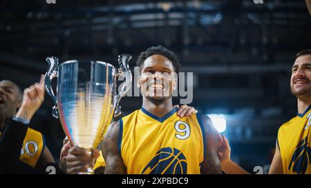 Happy Diverse Sports Team Victorious at Basketball Association Playoffs: Group of Players Celebrate the Victory with a Coach. Close-Up Portrait on Live Sports Broadcast Television Channel Concept Stock Photo
