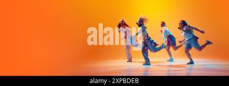 Banner. Group of dancers performing in vibrant neon light against gradient studio background with negative space to insert text. Stock Photo