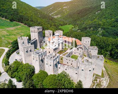 Aerial view of Manasija Monastery in Serbia, showcasing its medieval walls and fortifications surrounded by mountains and forests Stock Photo