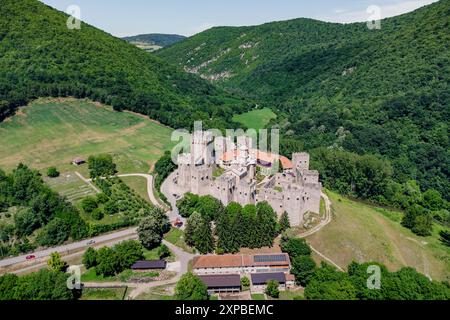 Aerial view of Manasija Monastery in Serbia, showcasing its medieval walls and fortifications surrounded by mountains and forests Stock Photo