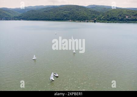 09 June 2024, Golubac, Serbia: Aerial view of a summer regatta on the Danube River in Serbia, with sailboats racing under a clear blue sky, showcasing Stock Photo