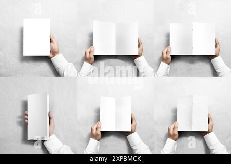 Hand holding blank white flyer brochure booklet in hand, 3d rendering. Empty twofold paper booklet in arm mock up, grey background. Clear commercial p Stock Photo