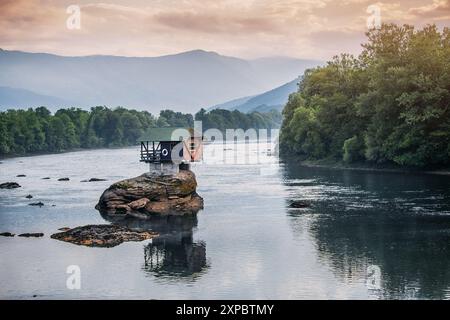 A romantic house cabin by the Drina River, nestled in a beautiful Balkan valley with stunning views of the river and surrounding nature Stock Photo