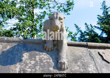 A stone panther on Animal Walk, Bute Park, Cardiff UK. Sculpture in 1880s by William Frame to the designs drawn by William Burges. Stock Photo