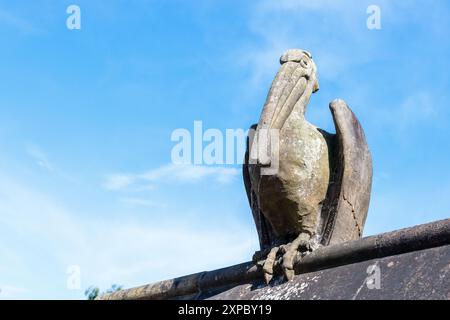 A stone Pelican on Animal Walk, Bute Park, Cardiff UK. Sculpture in 1880s by William Frame to the designs drawn by William Burges. Stock Photo