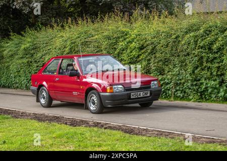 1990 90s nineties Red Ford Escort Popular Hatchback Petrol Engine 1297 cc; arriving in Worden Park Motor Village for the Leyland Festival, UK Stock Photo