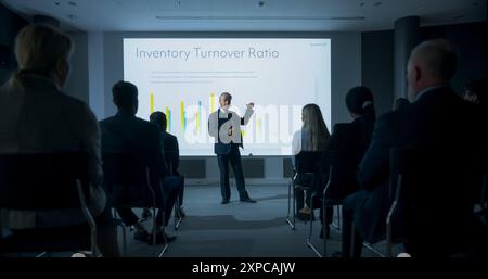 Corporate Event: Caucasian Male Tech CEO Giving Presentation To Colleagues or Investors In Conference Room Of Innovative Startup Office. Man Talking About Business Objectives and Improving Profits. Stock Photo