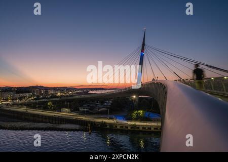 Sunset over the city of Pescara, Abruzzo, Italy. Breathtaking view from the Ponte del Mare, a bicycle and pedestrian cable-stayed bridge. Stock Photo