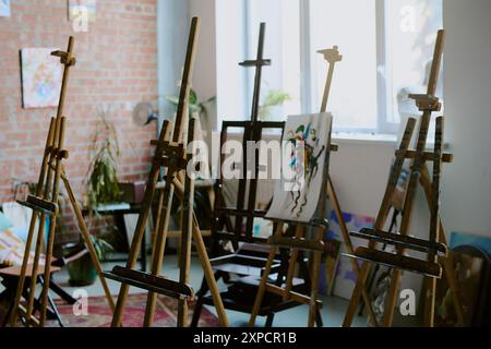 No people shot of set of wooden easels in modern art school room interior, copy space Stock Photo