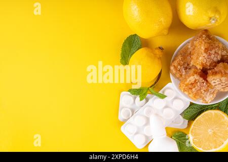 Cold and flu autumn season concept, traditional and alternative cold and flu treatments, pills, drops for runny nose, lemon, honey and mint on bright Stock Photo