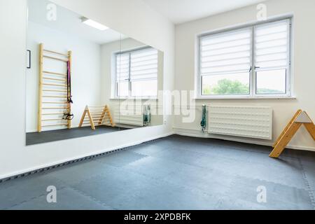 Empty physio therapy room with wooden exercise tools. Stock Photo