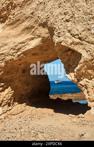 Through passage in the rock near the sea Stock Photo - Alamy