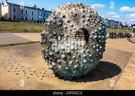 A large textured circular sculpture,  Mothership, by Rachel Joynt, on the seafront in Dun Laoghaire, Dublin, Ireland. Stock Photo