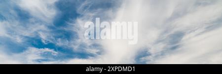 Blue sky between white clouds. Sky background texture Stock Photo