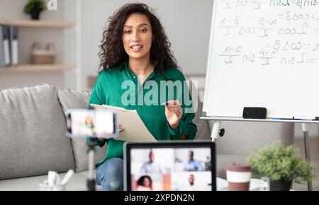 Female teacher explaining math online making video call Stock Photo