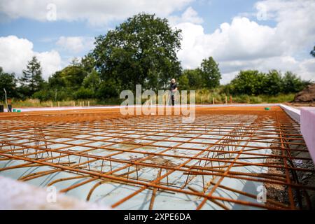 A male construction worker standing on a construction site. Family house build concept  Stock Photo