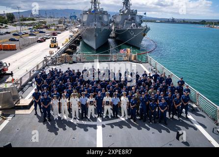 The crew of U.S. Coast Guard Cutter Waesche (WMSL 751), a Japan Coast Guard delegation and exchange program participants from the Japan and Philippine Coast Guards pose for a photo on the cutter’s aft deck during a ceremony on Joint Base Pearl Harbor-Hickam in Honolulu, Hawaii, Aug. 3, 2024. The Waesche crew held a disembarkation ceremony celebrating foreign observers who participated in missions aboard the cutter during portions of the crew’s Indo-Pacific patrol. (U.S. Coast Guard photo by Chief Petty Officer Corinne Zilnicki) Stock Photo