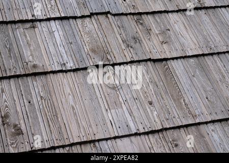 wood tile roof, a typical tradition of many mountain places due to the abundance of natural material. present rope hook for safety. Stock Photo