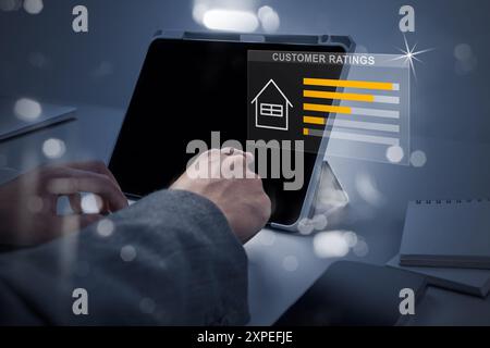 A person is typing on a laptop with a screen displaying customer ratings. Concept of a person working on a computer, possibly in a professional settin Stock Photo
