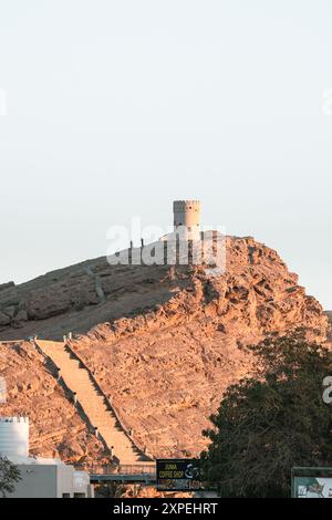 View on the watch tower in coast town Sur, Oman during sunset  Stock Photo