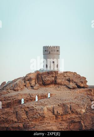 View on the watch tower in coast town Sur, Oman during sunset  Stock Photo