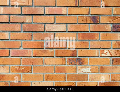 Modern brick wall with cement joints red/orange colored finish background. Stock Photo