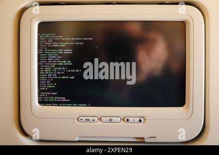 Passenger airplane console screen displaying Linux terminal. Stock Photo