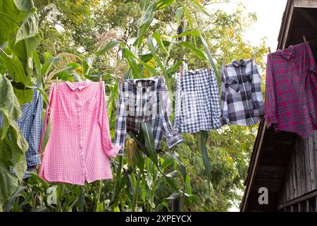 A view of country hipster clothes hanging on a clothesline. Stock Photo
