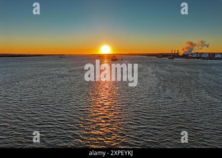 Aerial View of Sun Setting over the Water Stock Photo