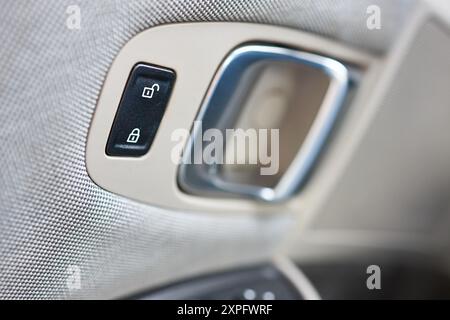 Car Door Lock Button Closeup. Electric Locking Button in Modern Car. Unlocking and locking buttons for central locking system and security against Stock Photo