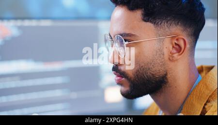 Serious, man and coding with computer for cybersecurity, developer update and app upgrade. Thinking, working and coder tech with programmer search and Stock Photo