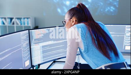 Woman, computer screen and thinking in office for code, software development and programming. Female developer, tech and reading at desk for Stock Photo