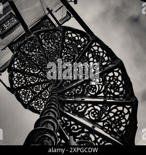 Close up of beautiful wrought iron exterior spiral staircase on the side of a building in Aldeburgh, Suffolk,  with copy space for design Stock Photo