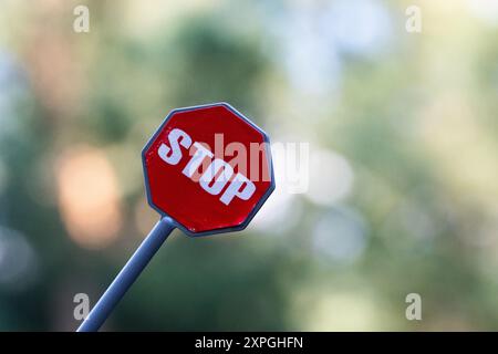 Stop sign on blurred background with bokeh effect Stock Photo