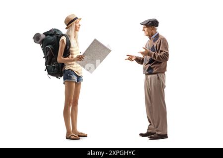 Female tourist with a backpack holding a map and talking to an elderly man isolated on white background Stock Photo